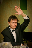 2011.12.26 Signaling to the anchorperson of the the company's celebration of the New Year 2012 about having an answer. 
© 2011 Sergey Lakeev