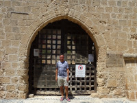 2021.07.28 At one of the closed for entrance gates of the Monastery of Ayia Napa (Ιερά Μονή Αγίας Νάπας), with the horizon aligned to the ground but tilted as compared to the masonry.