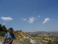 2021.08.02 Against the background of a mountain landscape at the entrance to the Cypriot village of Lefkara (Λεύκαρα): I am on the left, the landscape is on the right.